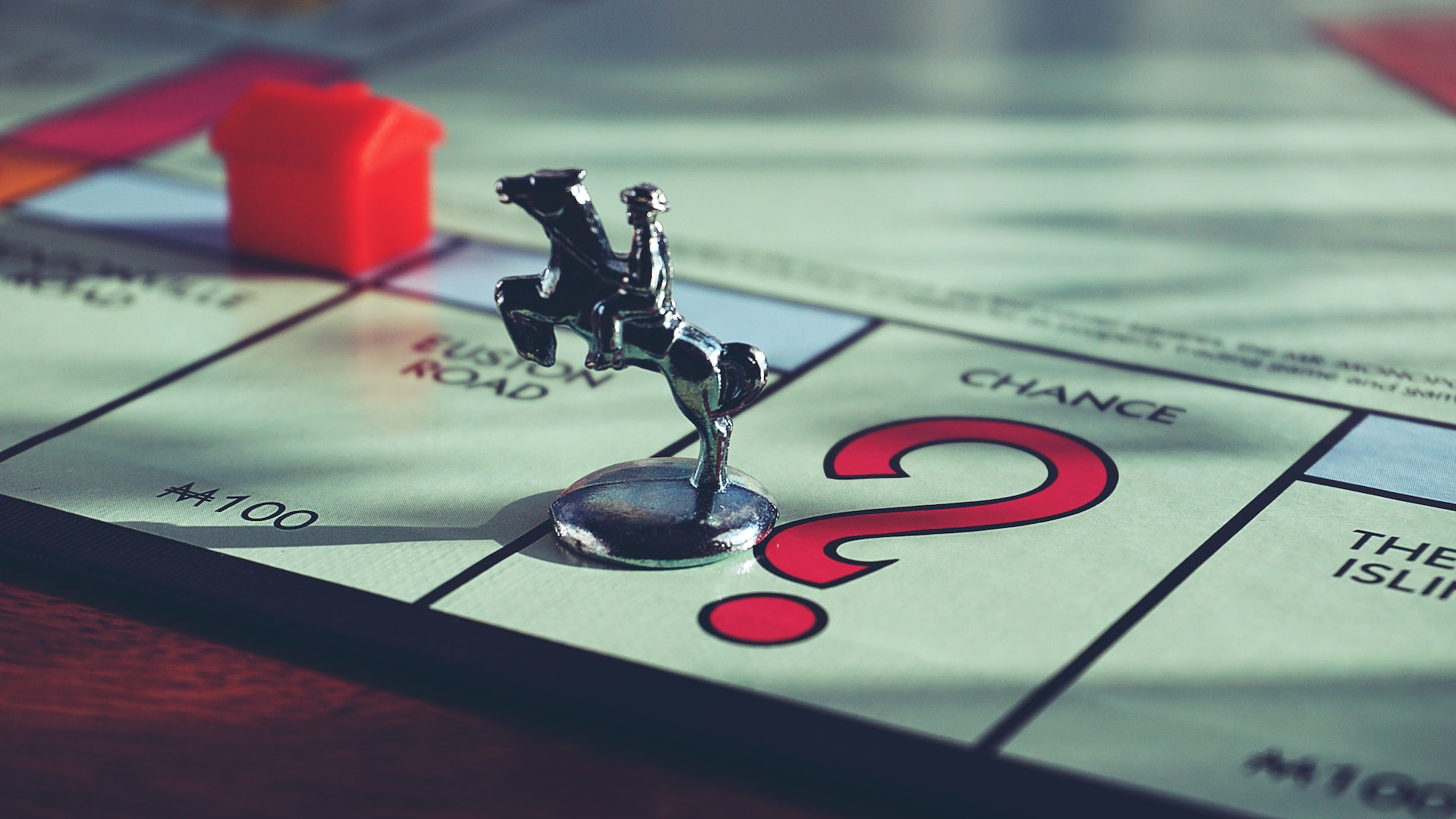 a monopoly horse and rider piece on the "chance" square of the board